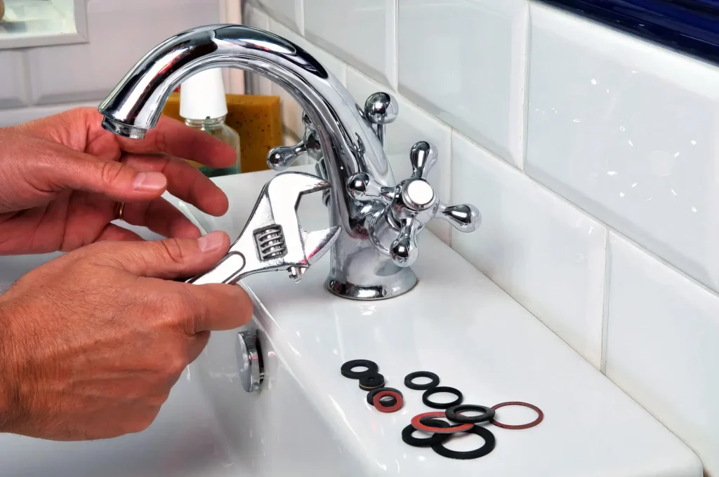 Plumber performing maintenance on a bathroom faucet in Pittsburgh
