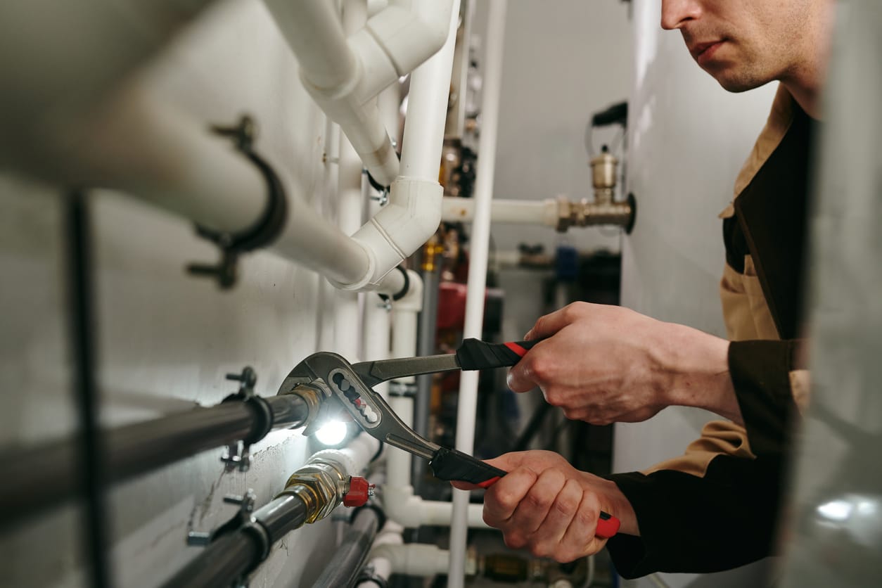 Plumbers maintaining commercial plumbing pipes in Pittsburgh