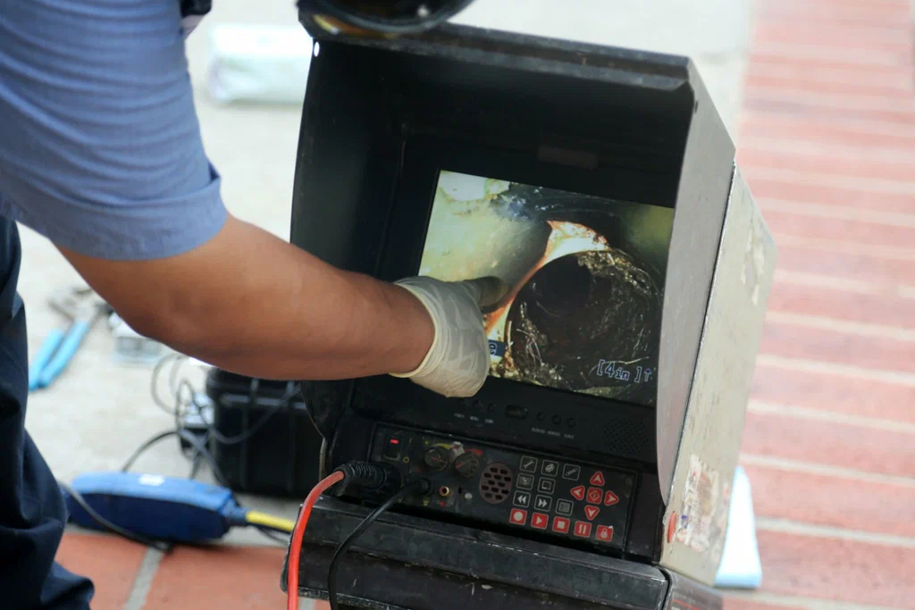 Technician viewing a drain inspection camera in Pittsburgh