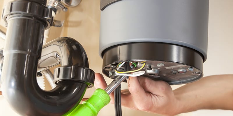 Technician repairing the heating element of a water heater in Pittsburgh