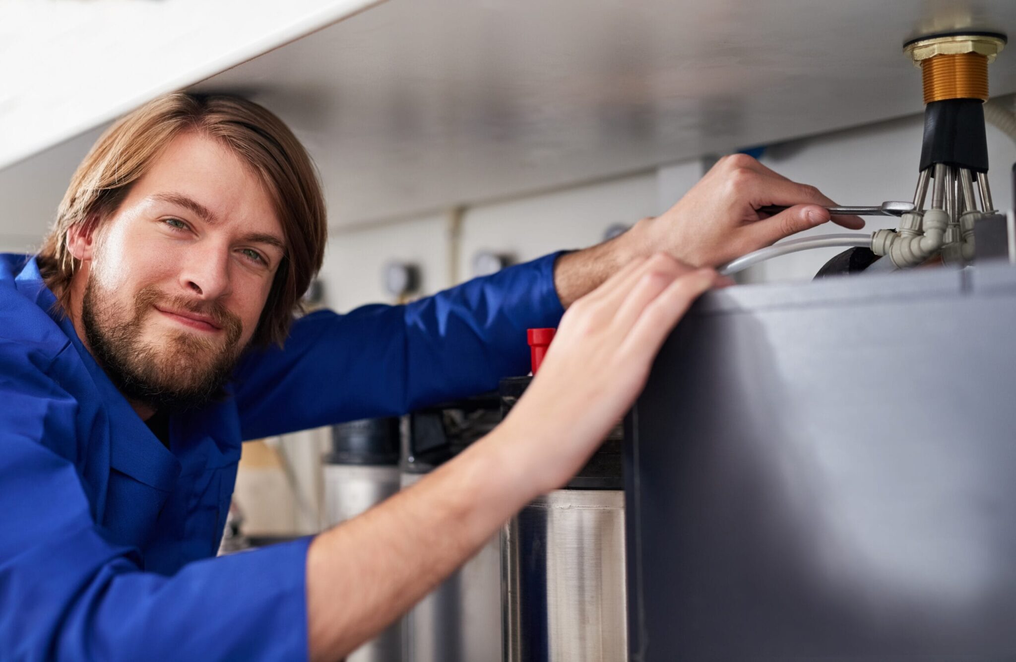 Technician servicing a residential water heater tank in Pittsburgh
