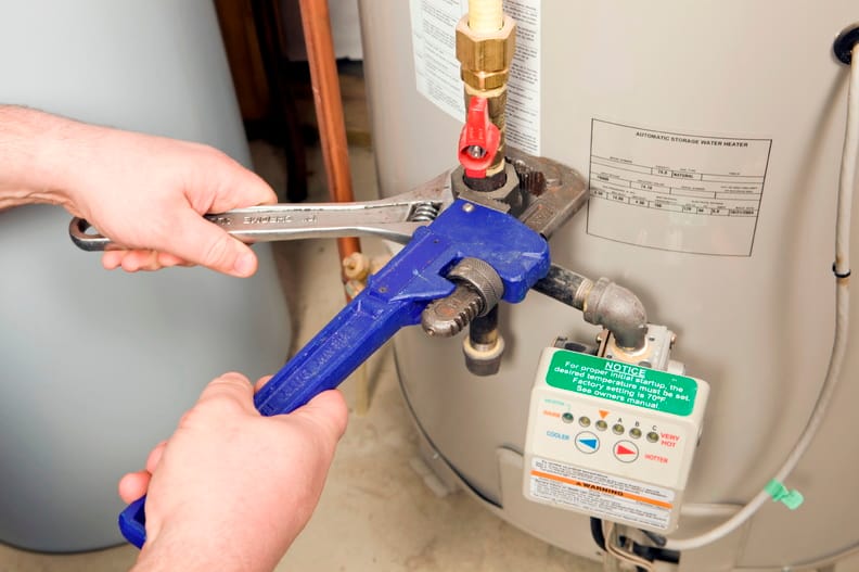 Plumber repairing a water heater valve in Pittsburgh